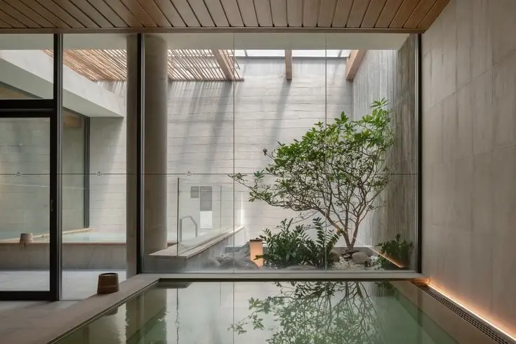Yutori-inspired onsen courtyard with timber ceiling, soaking pool and a tree at Hanya Wahyu, Taman Wahyu Kuala Lumpur